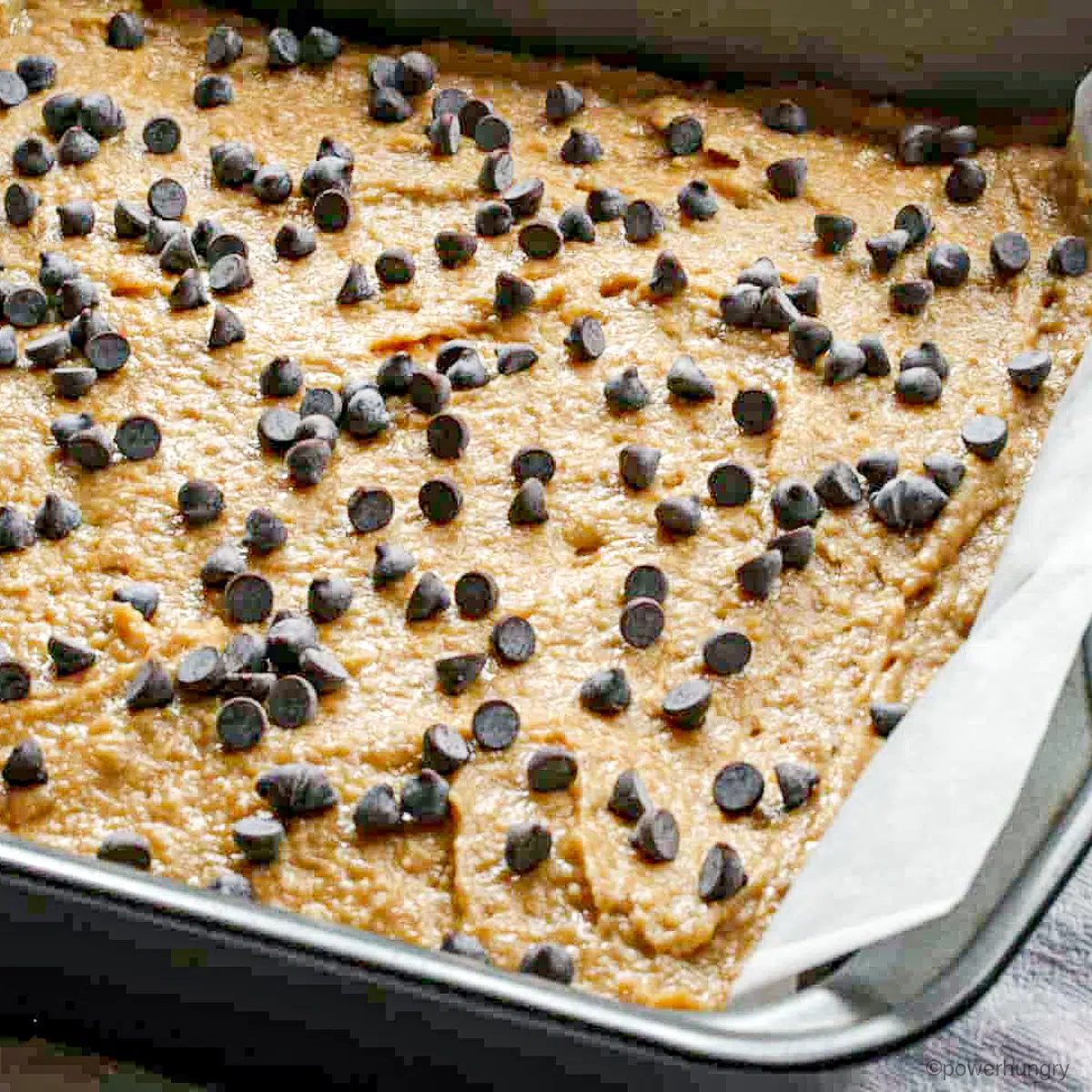 vegan coconut flour blondies batter in pan with chocolate chips