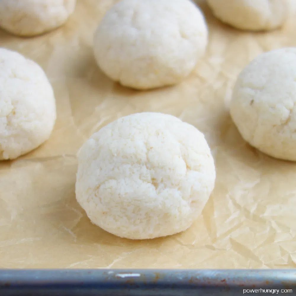 coconut flour dough shaped into rolls on a baking sheet