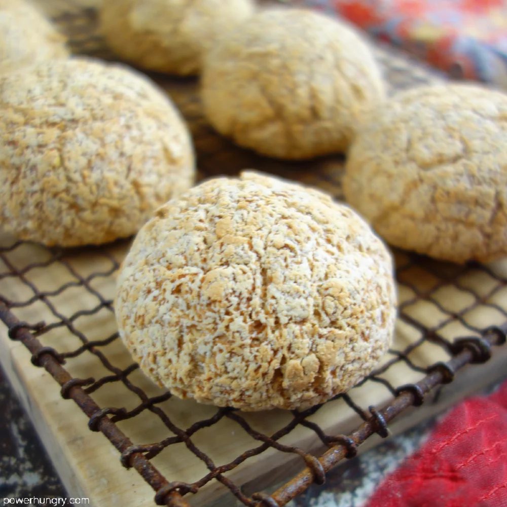 close up of coconut bread rolls on a wire rack