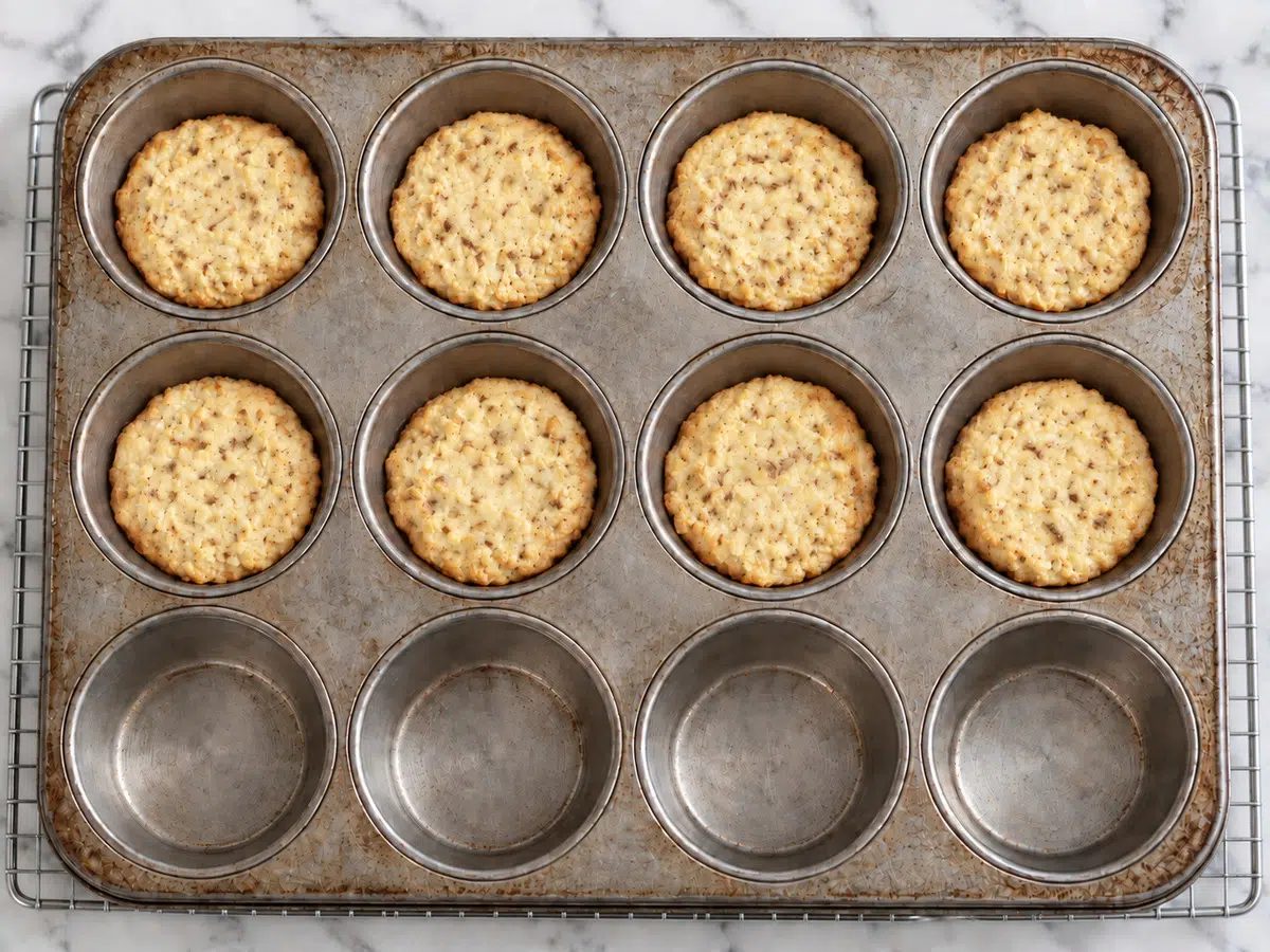 baked cauliflower biscuits with coconut flour still in muffin tin