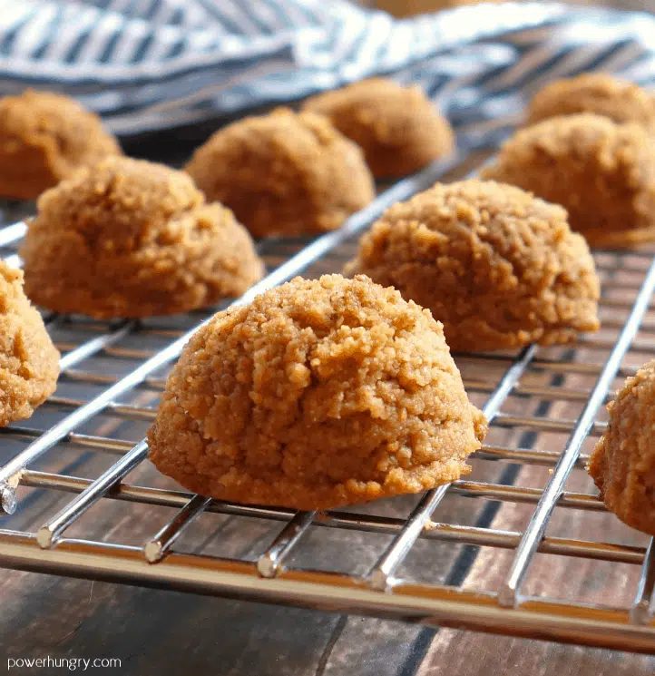 coconut flour lentil cookies on a silver cooling rack, a blue and white napkin in the background