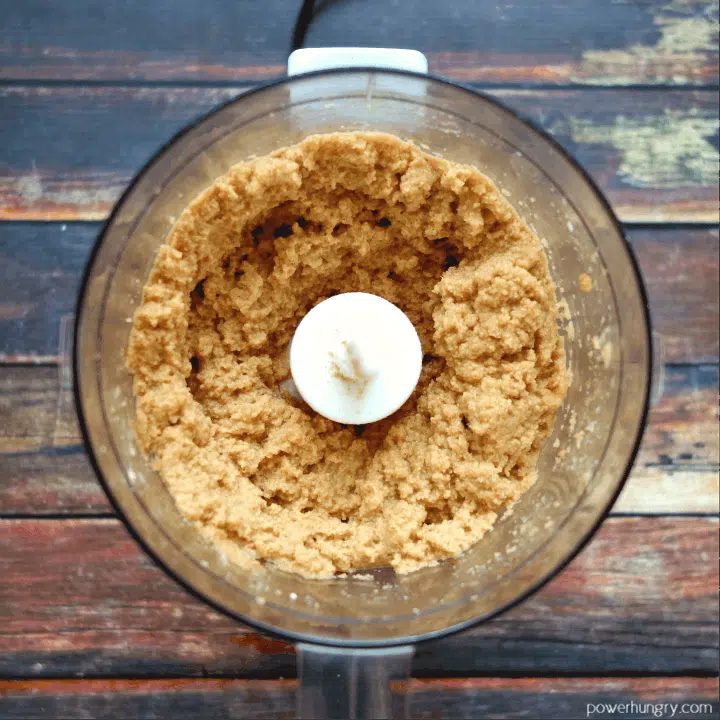 overhead shot of food processor filled with dough for lentil cookies