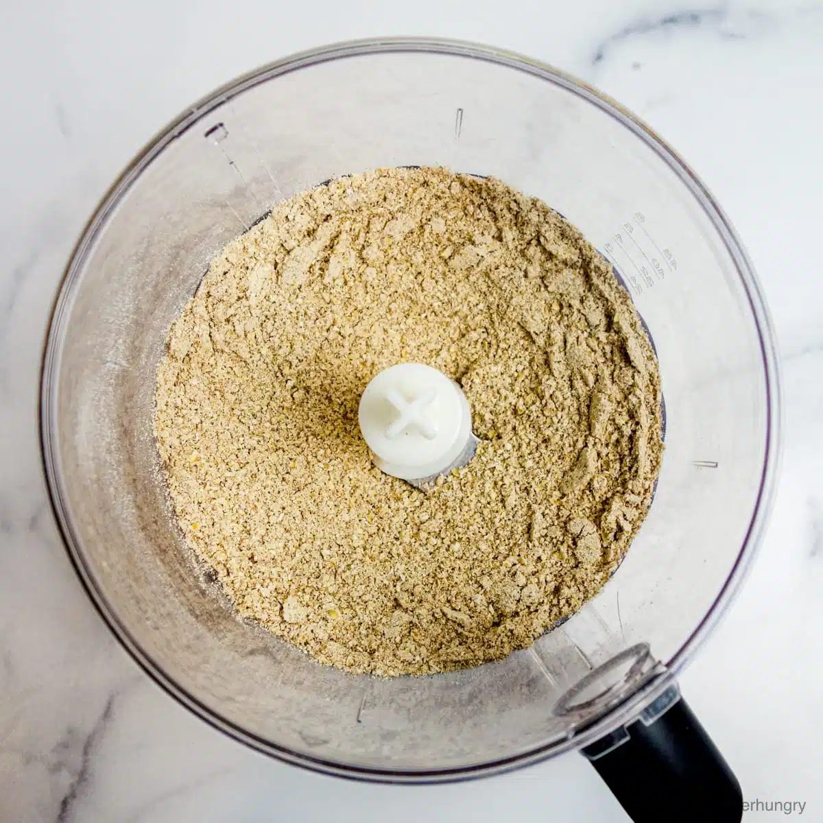 overhead shot of the combined dry ingredients, in a food processor bowl, for gingerbread coconut flour scones