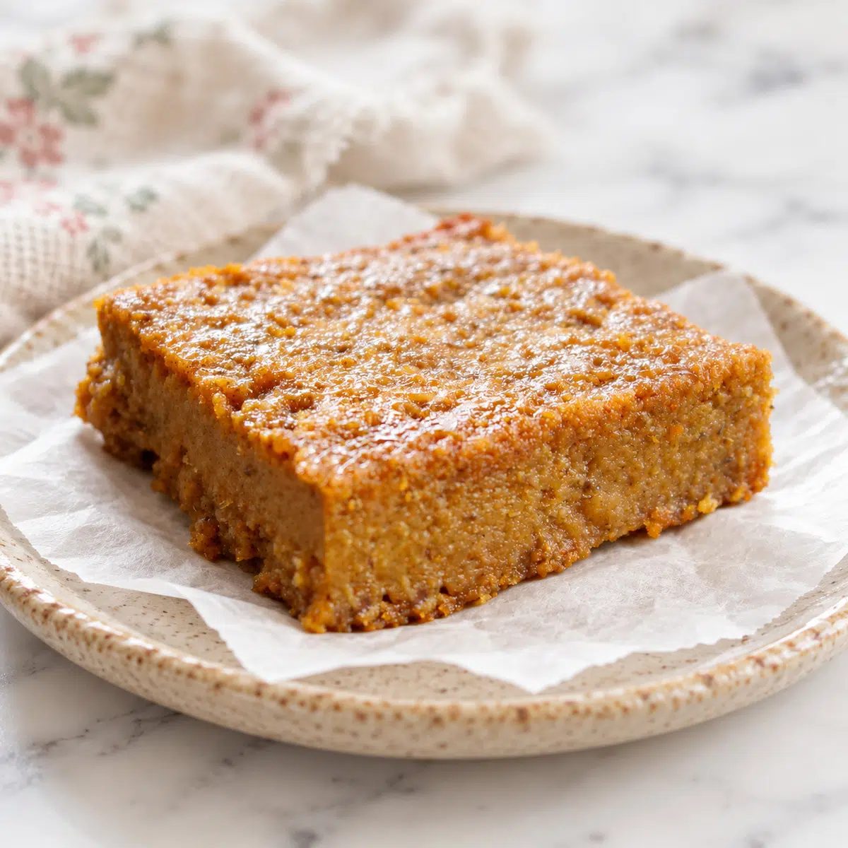 a single vegan pumpkin pie bar on a plate