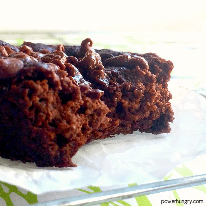 Close up of a vegan zucchini brownie on a piece of parchment paper
