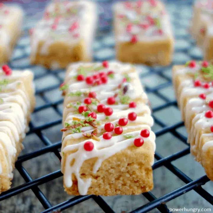 Close Up of Coconut Lime Chickpea Flour Shortbread on a black wire cooling rack