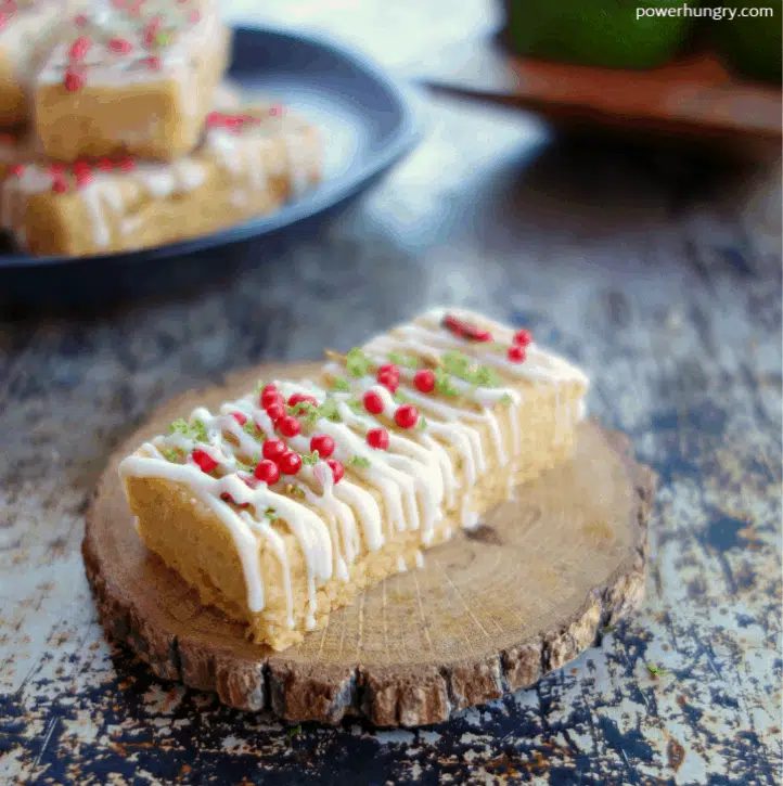 a Beautifully decorated cardamom, lime and coconut shortbread cookie on a small wooden plate