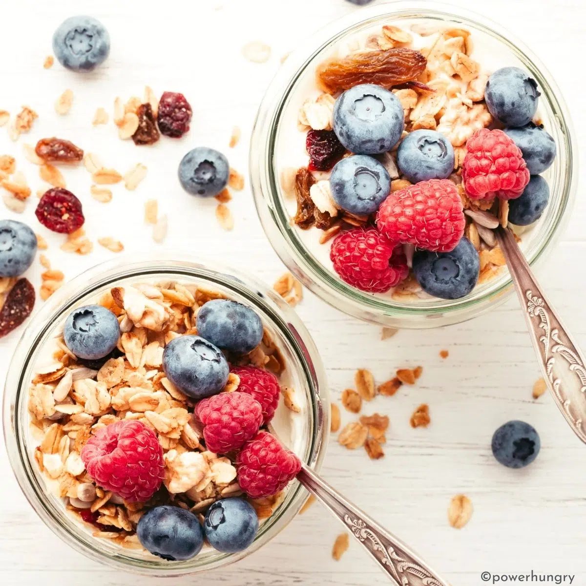two jars of nondairy yogurt with berries and coconut oil granola