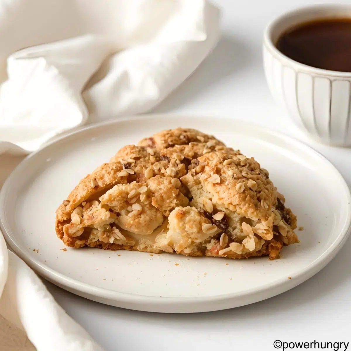 a single oat and pear scone on a white plate