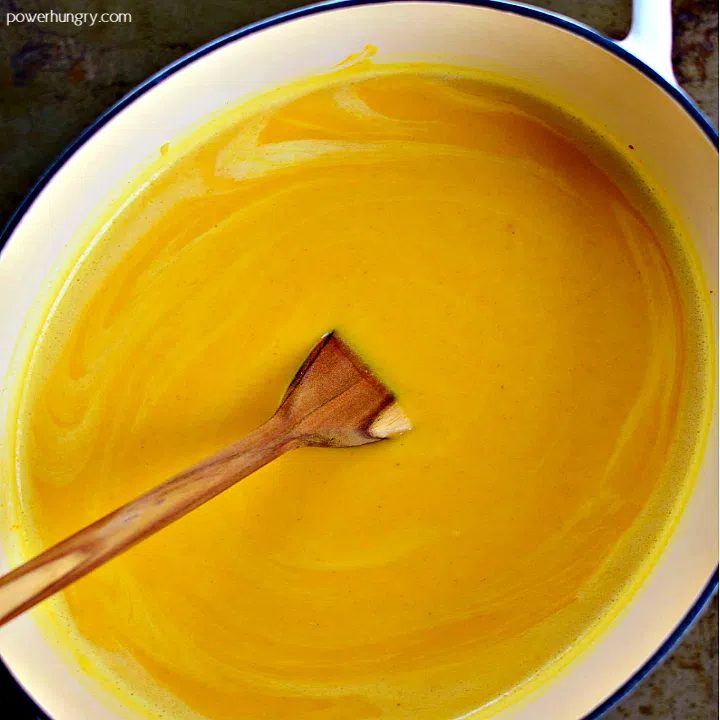 overhead shot of thai pumpkin coconut soup in a saucepan