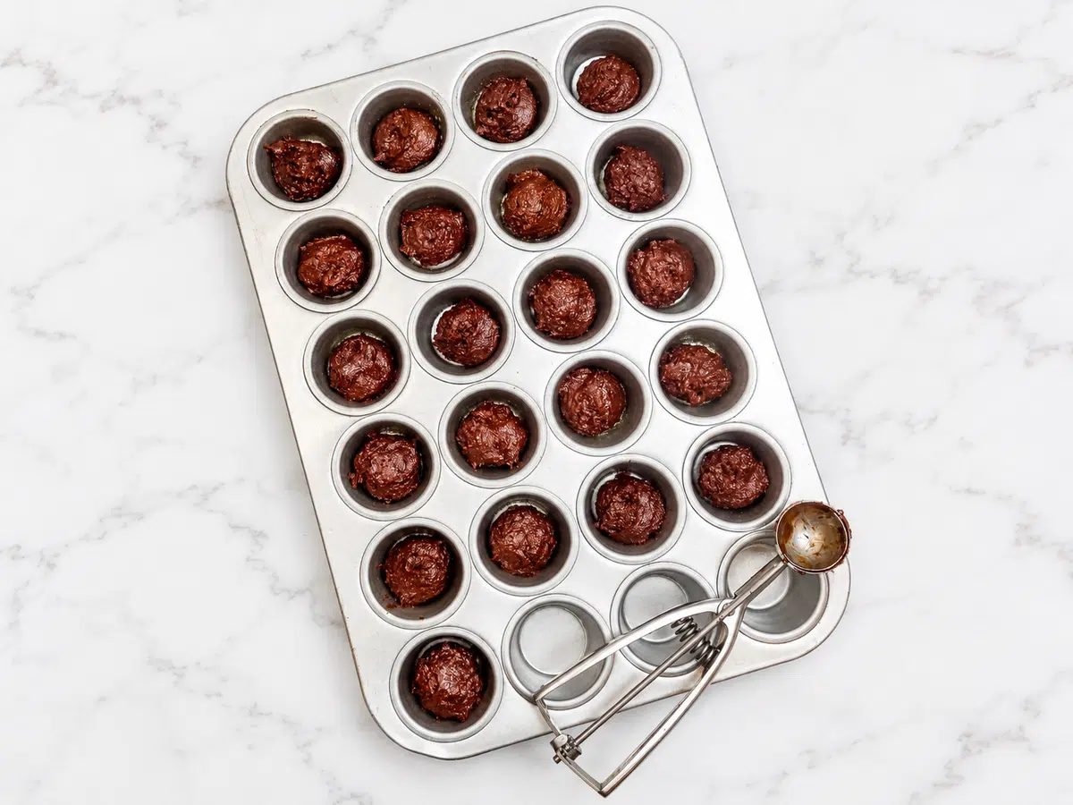 date brownies batter portioned into mini muffin cups