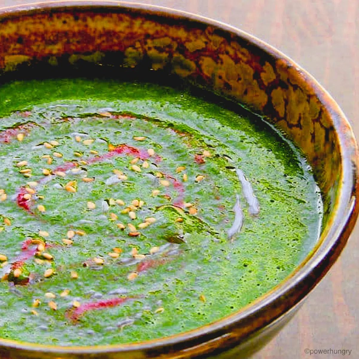 close up of pureed broccoli soup in an artisan pottery bowl