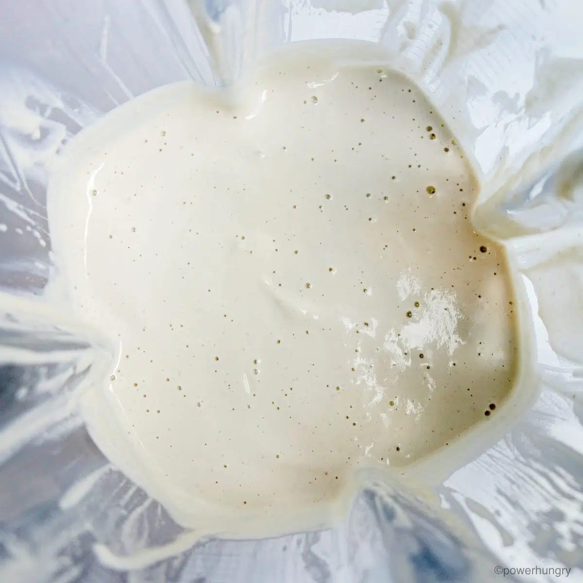 blended cashews in a blender container