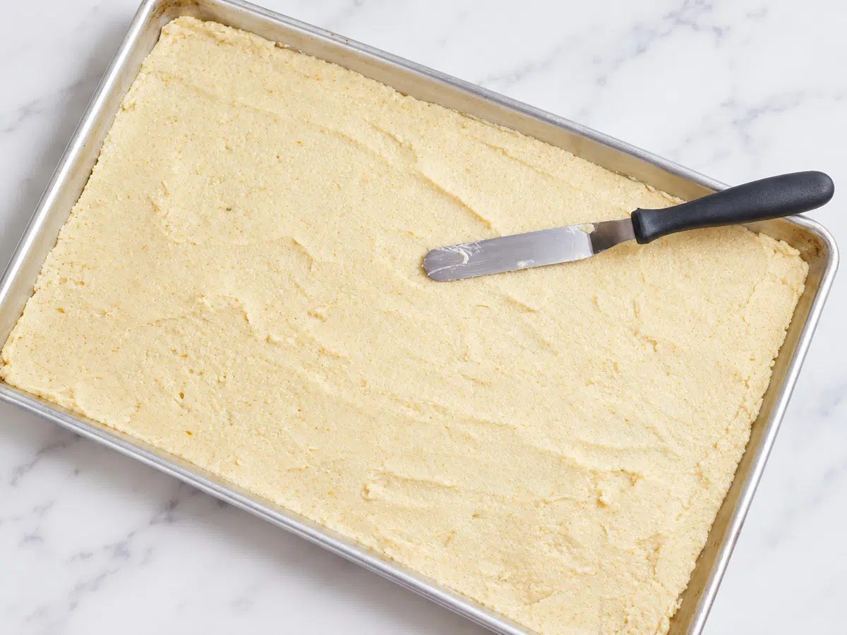 brown rice chips batter getting spread on baking sheet in thin layer