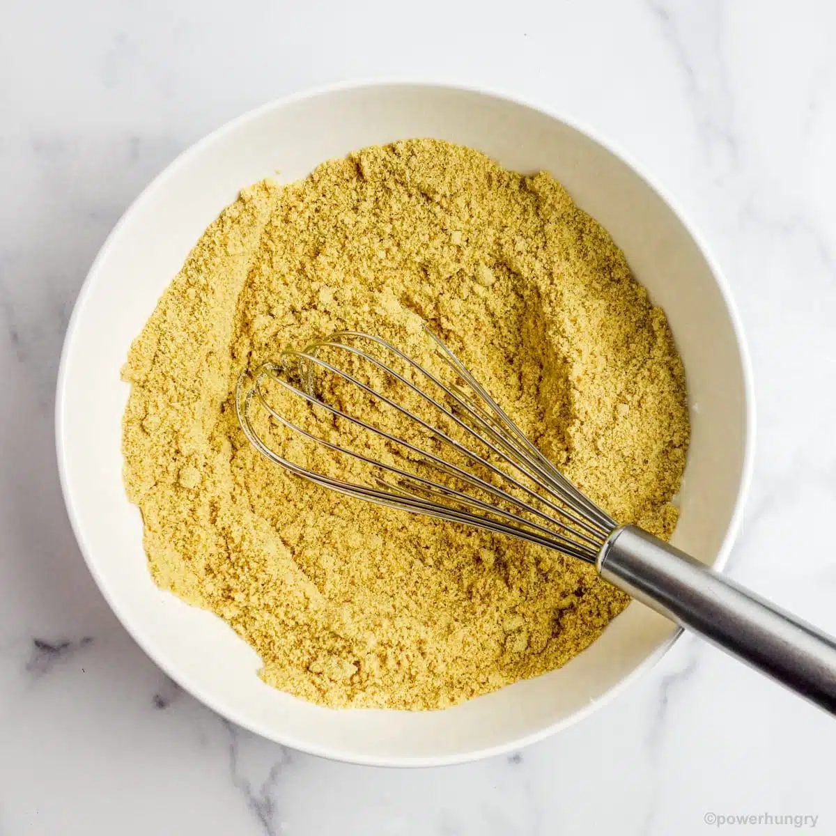 whisked flaxseed meal flour and baking powder in a white mixing bowl