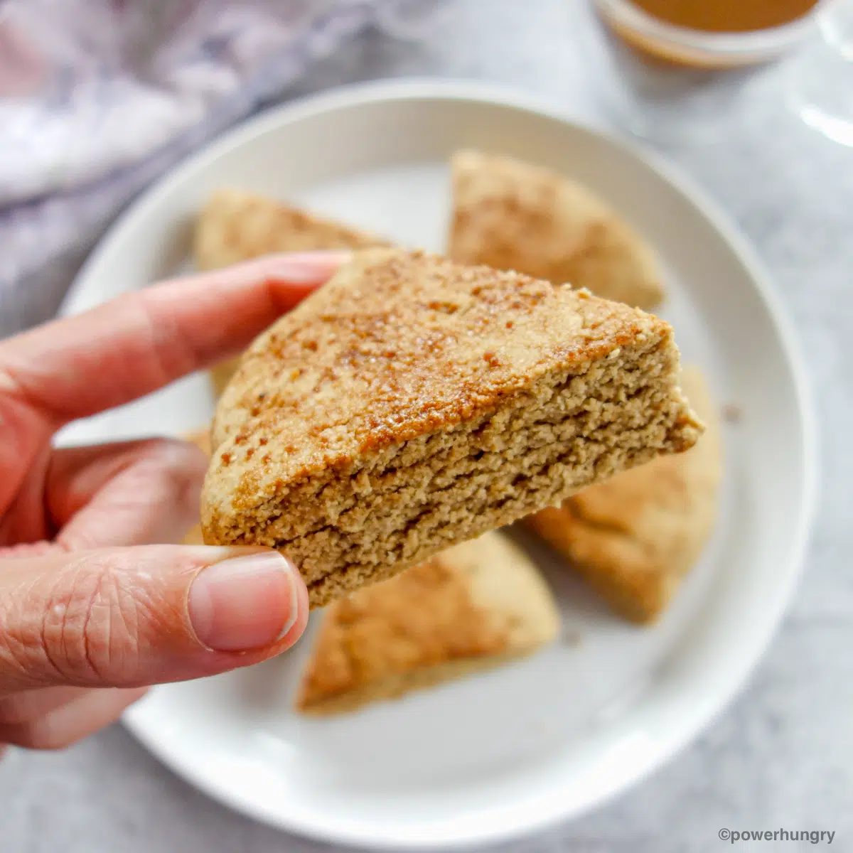 a single oat scone being held in a hand