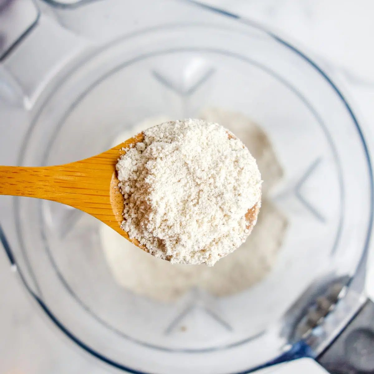 close up of a wooden spoon of oat flour