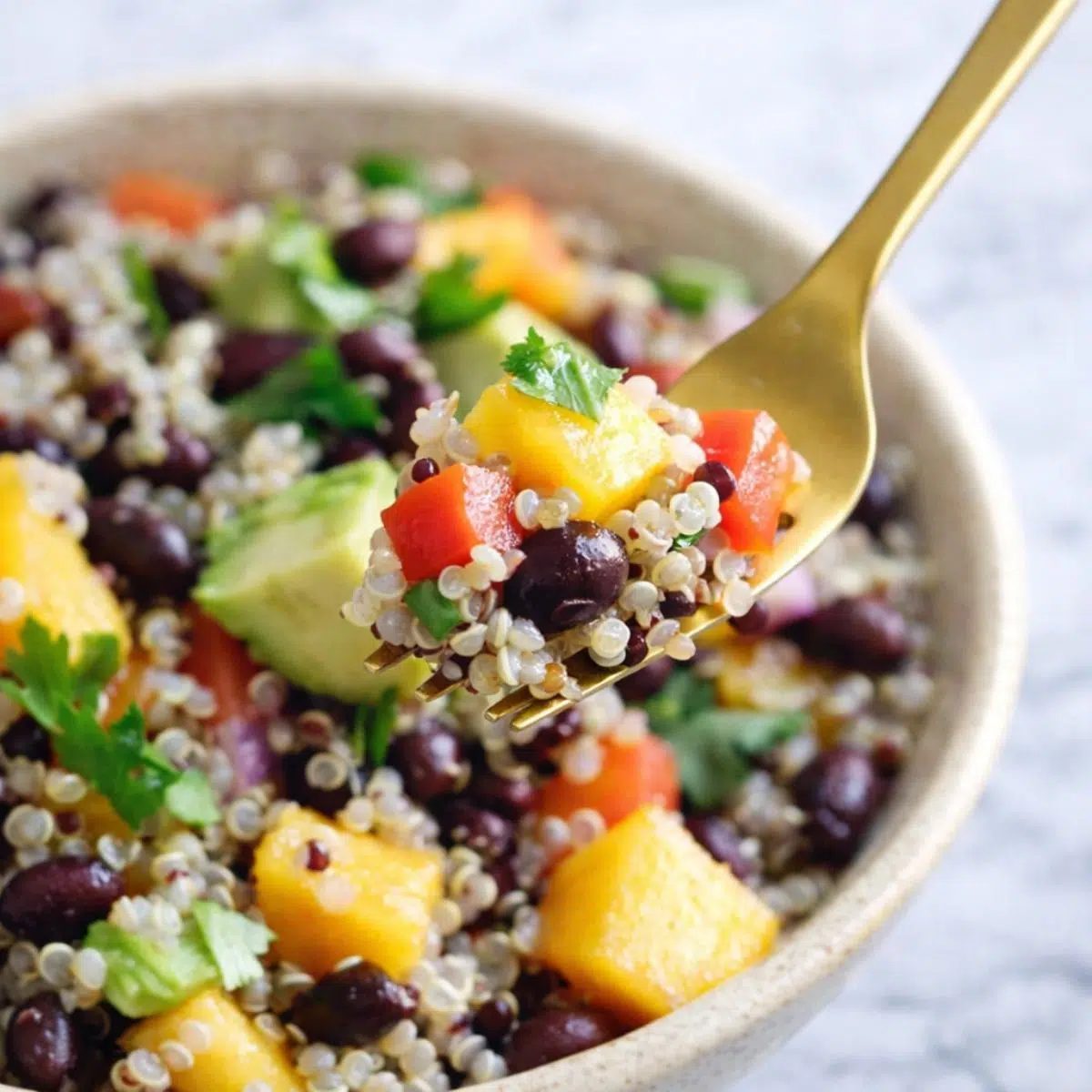 close up of forkful of black bean quinoa salad