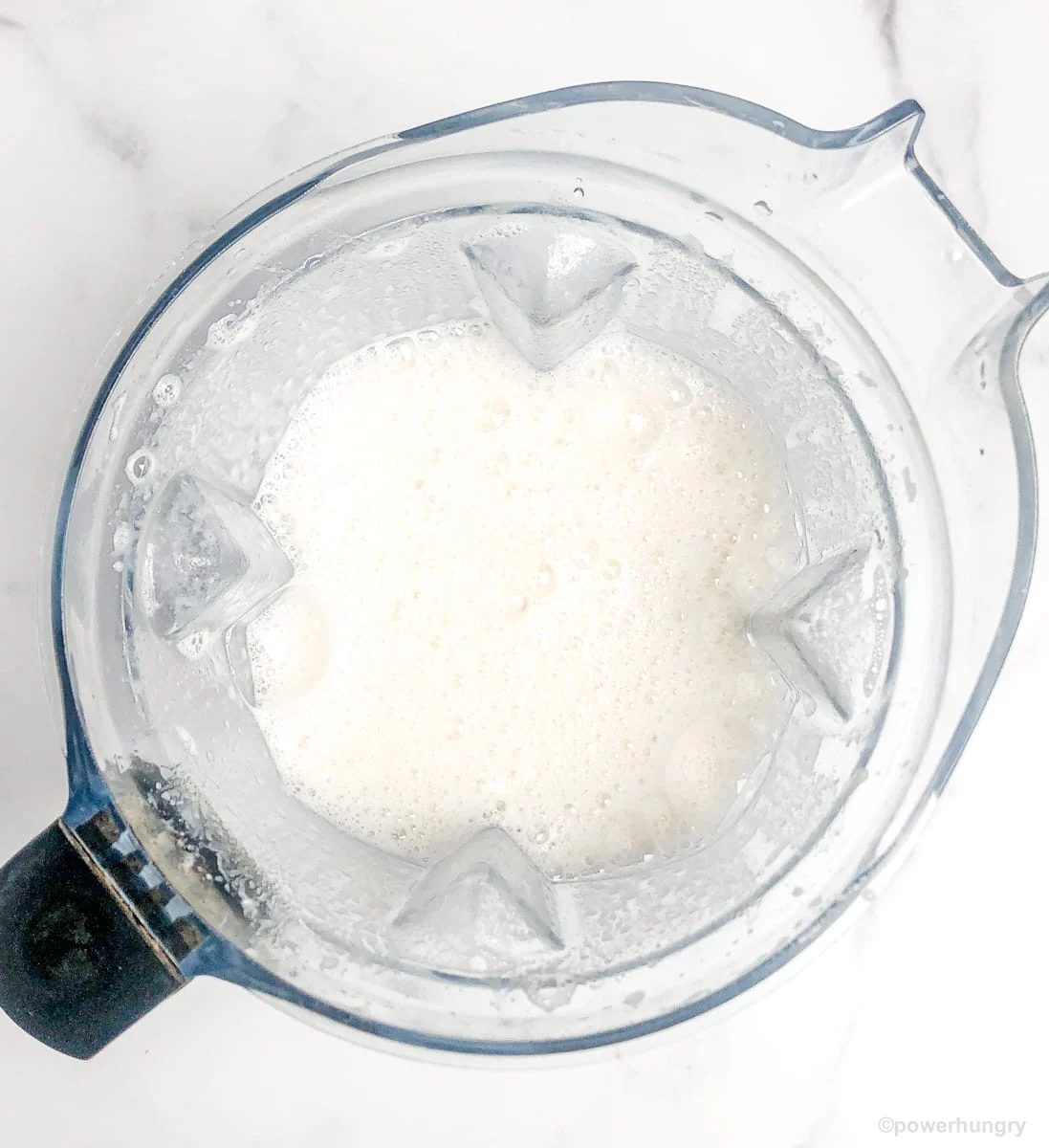 blended beans and water in a blender container