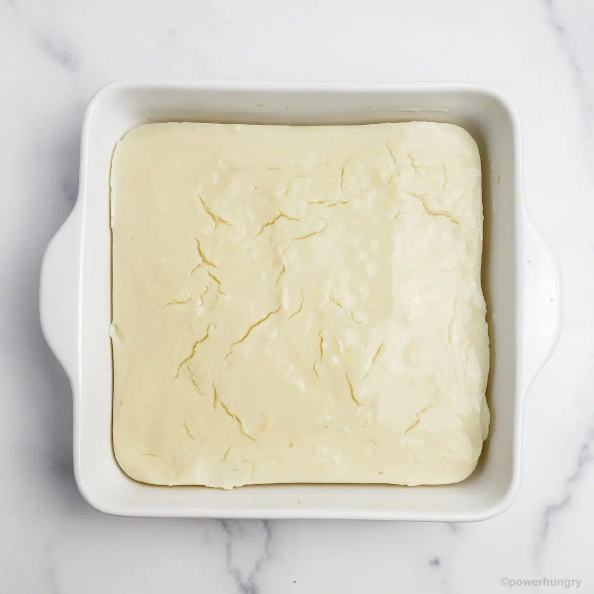 a white baking pan filled with set white bean tofu