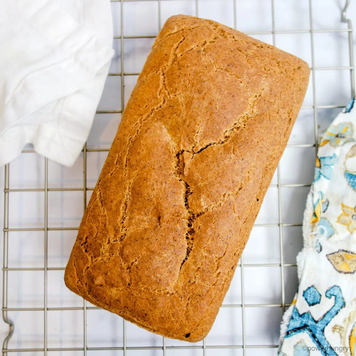 a loaf of grain-free vegan bread cooling on a wire cooling rack