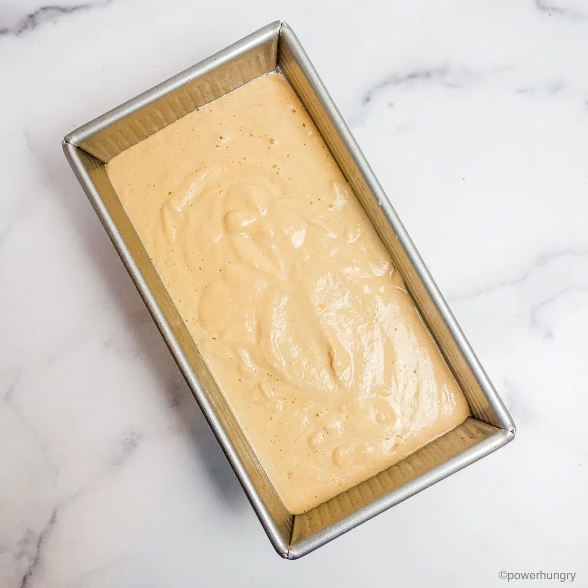 lentil sunflower bread batter in a metal baking pan