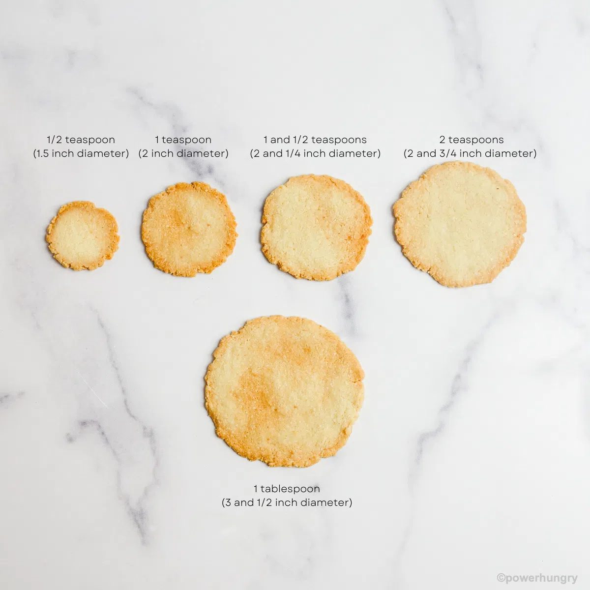 5 almond flour crackers of varying sizes on a white marble background