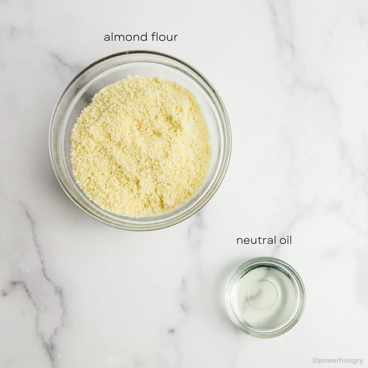 2 glass bowls, one filled with almond flour, one with oil