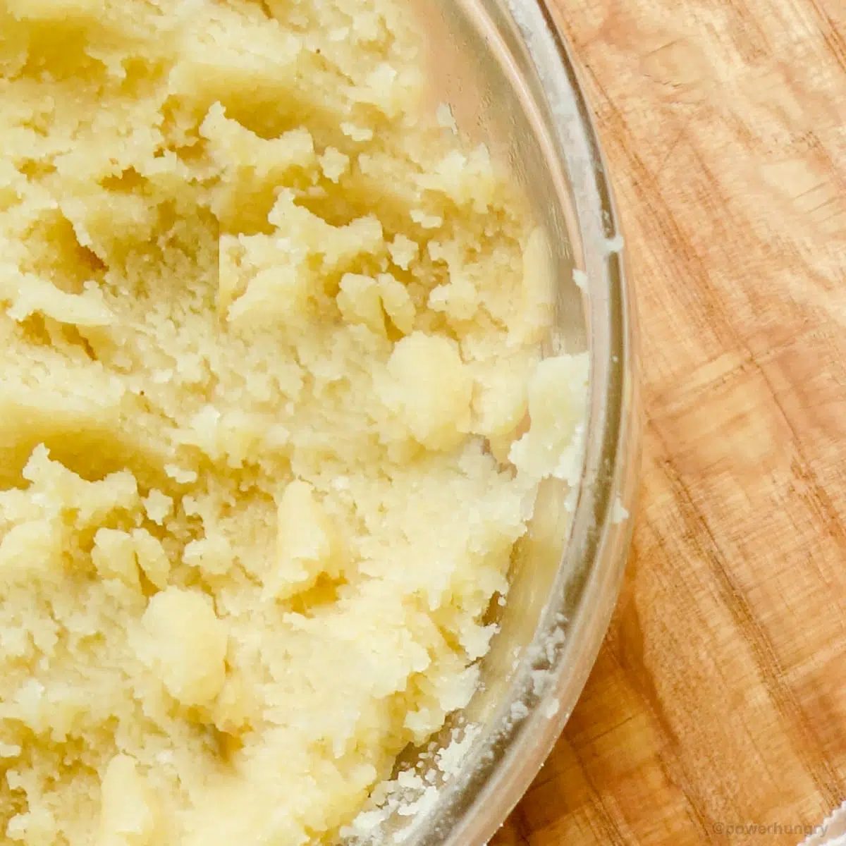 a glass bowl filled with almond flour cracker dough