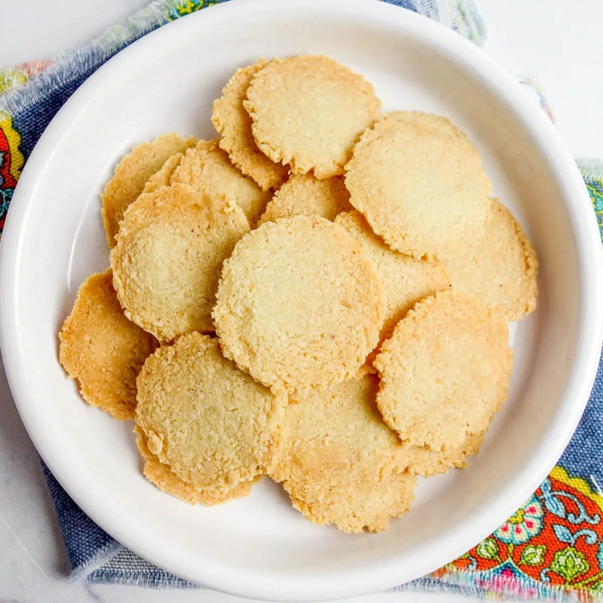 overhead shot of a white plate filled with almond flour crackers