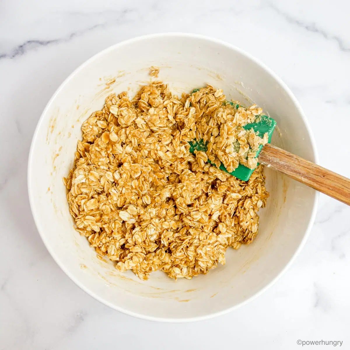 granola mix in a white mixing bowl