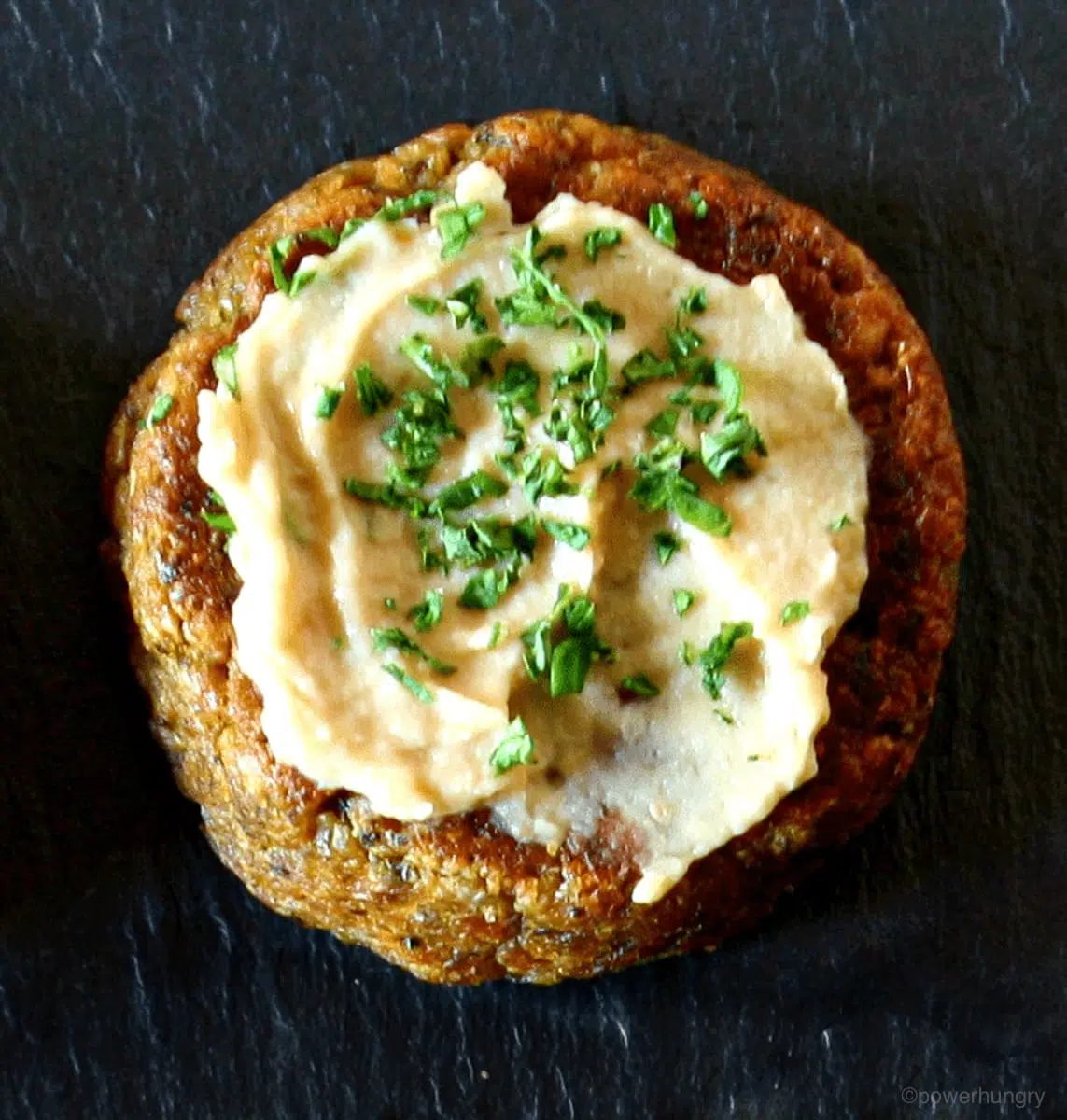 baked oil-free falafel patty with a spread of hummus on top
