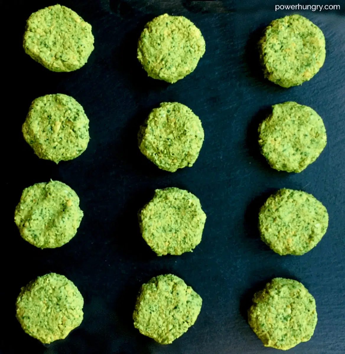 unbaked stack of baked oil-free falafel patties on a piece of slate