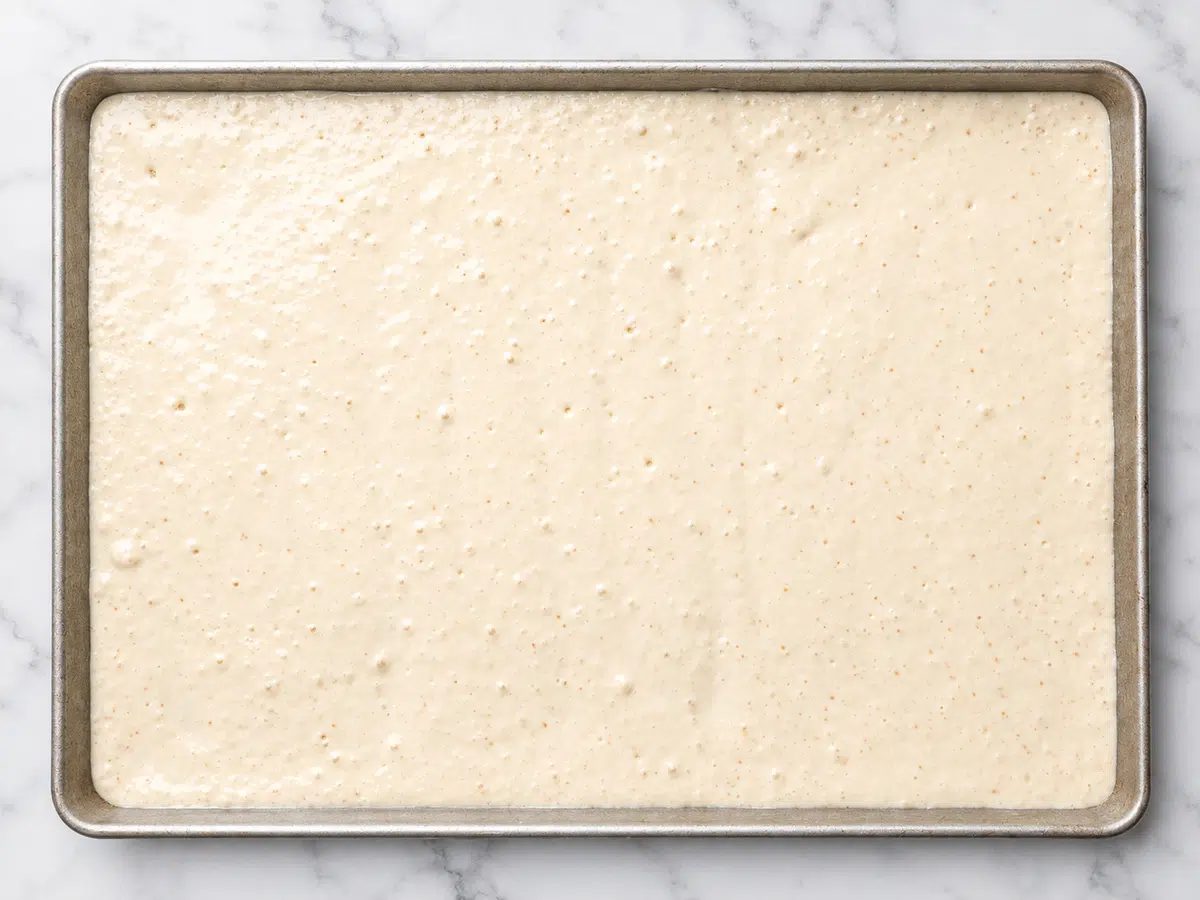 vegan sheet pancakes batter in a lined baking sheet pan
