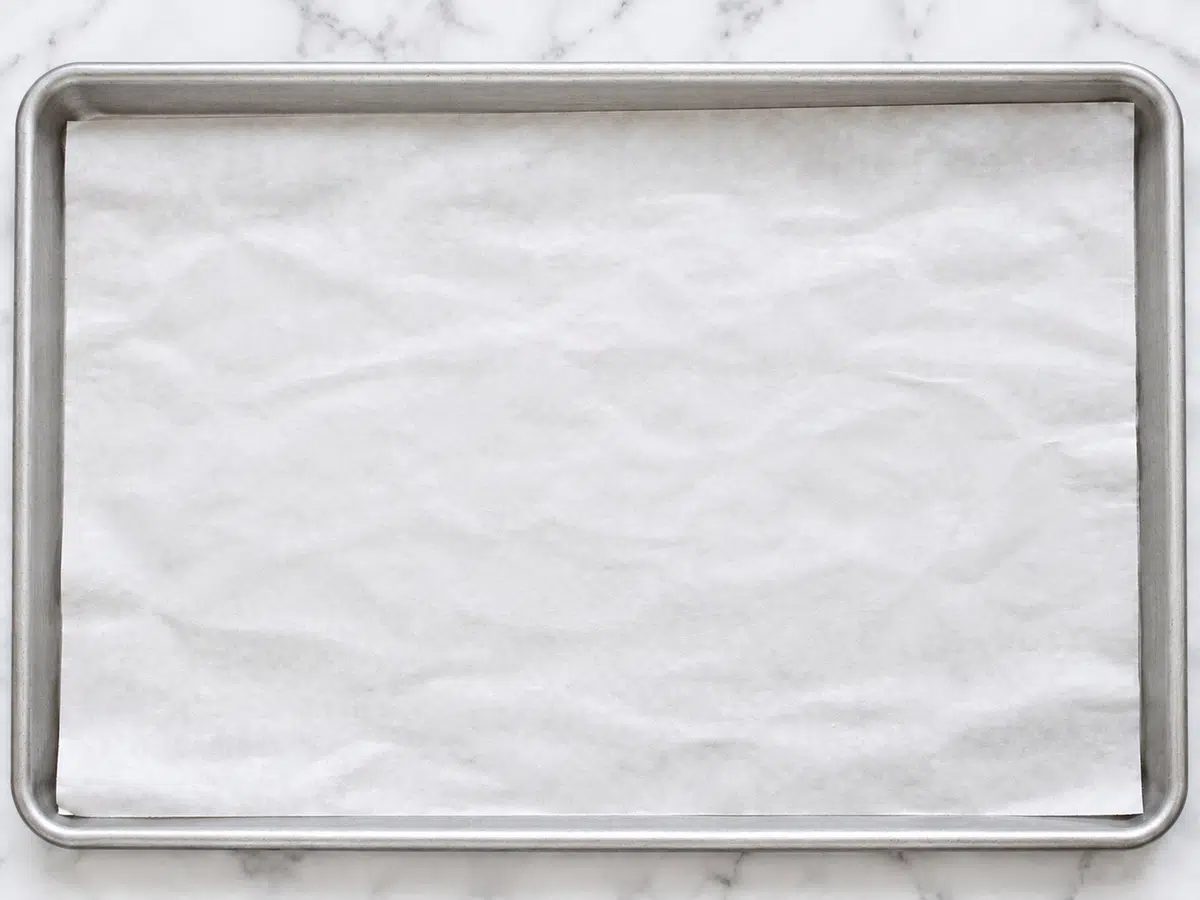 white parchment paper lined baking sheet
