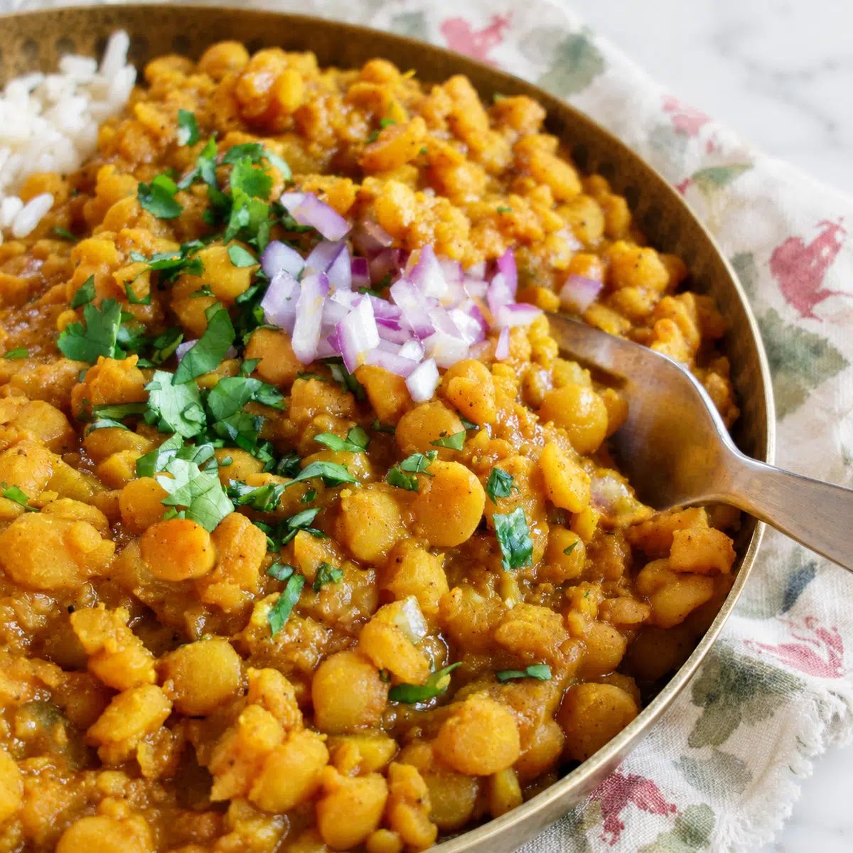 close-up of split pea curry in a brass bowl