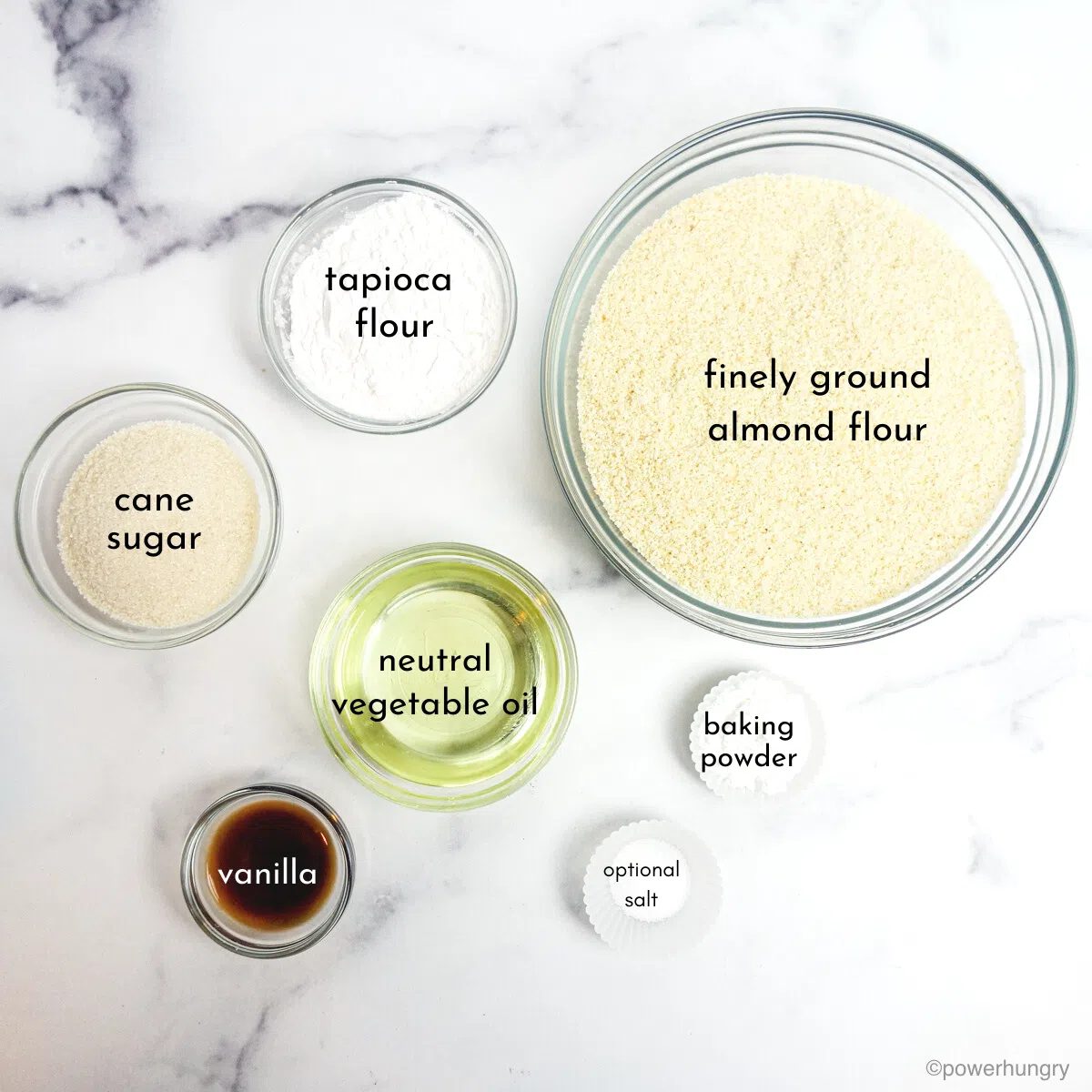 clear glass bowls, filled with scone ingredients, on a white marble surface