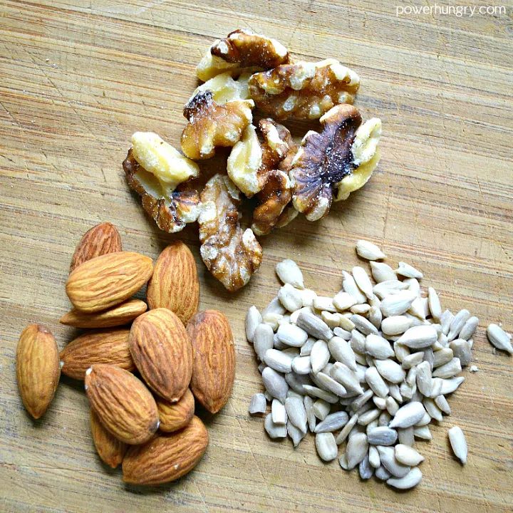 sunflower seeds, walnuts and almond on a cutting board