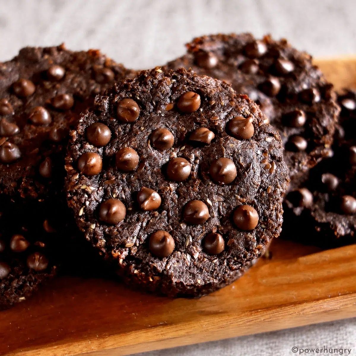 chocolate flaxseed cookies on a wooden plate