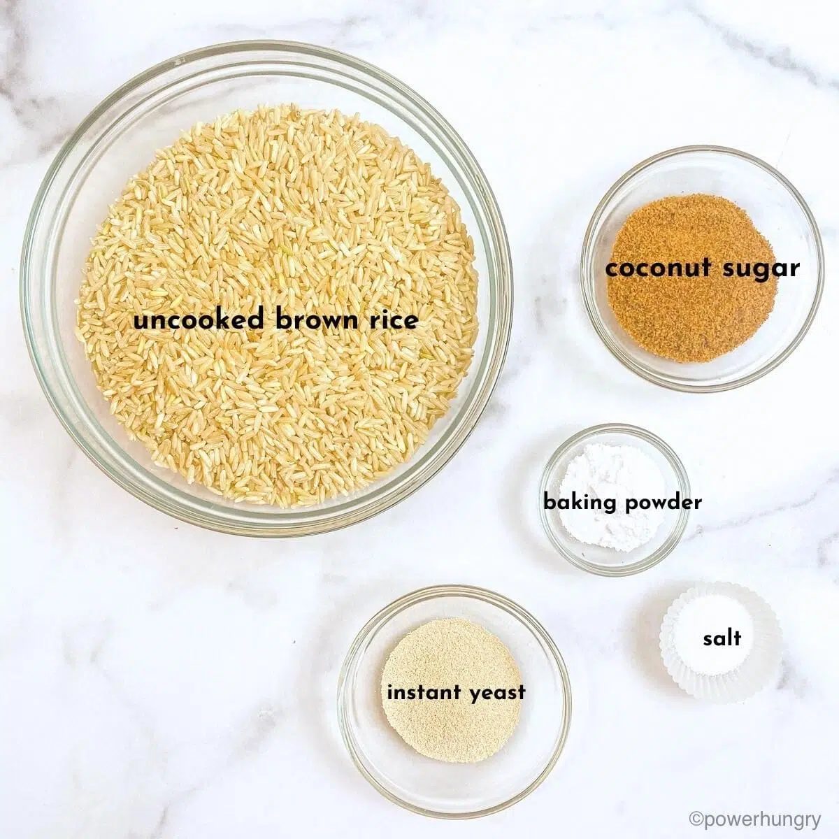 ingredients for brown rice yeast bread displayed in glass bowls