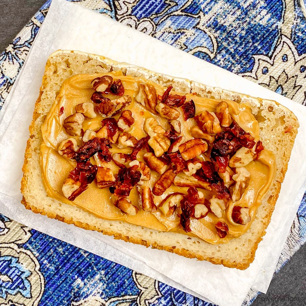slice of brown rice bread with nut butter and toppings