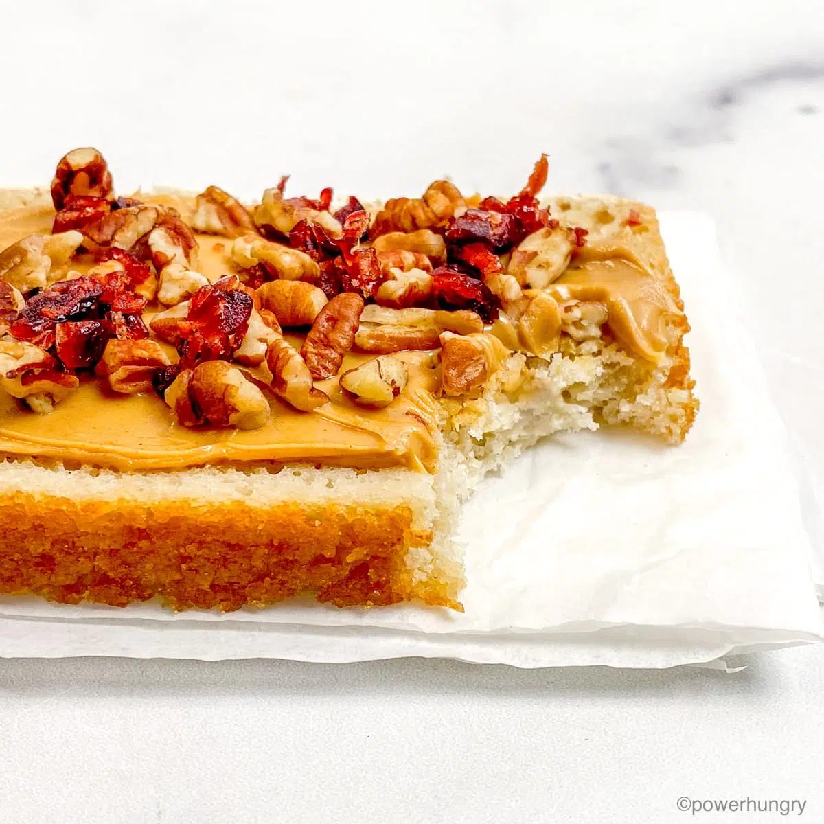 a piece of gluten-free bread, with toppings, with a bite taken out