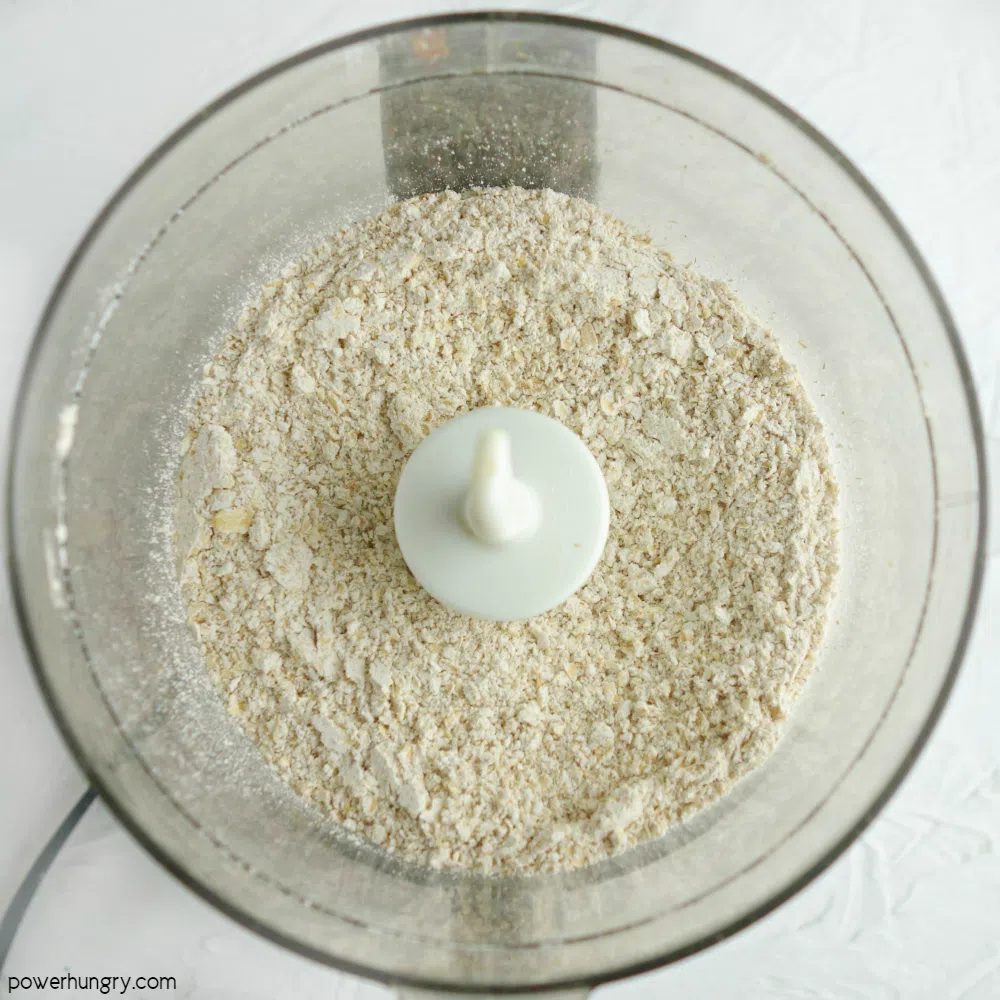 rolled oats in a food processor that have been ground into a flour