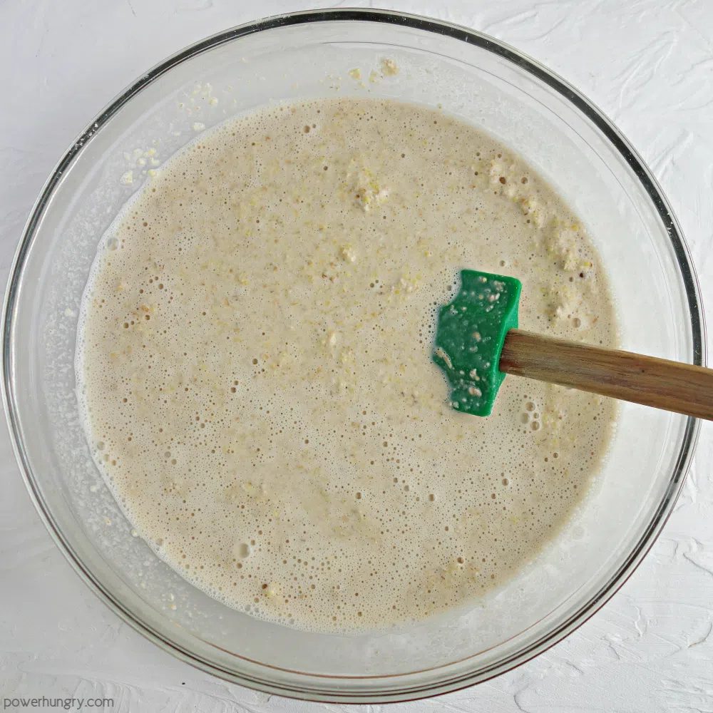glass bowl filled with millet oat bread batter
