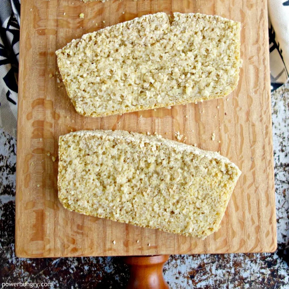 2 slices of millet oat bread on a wood cutting board