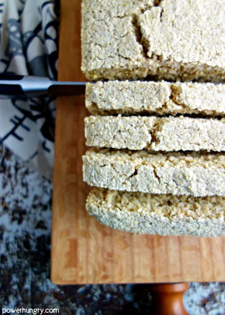 close-up of sliced milet oat bread on a wood cutting board