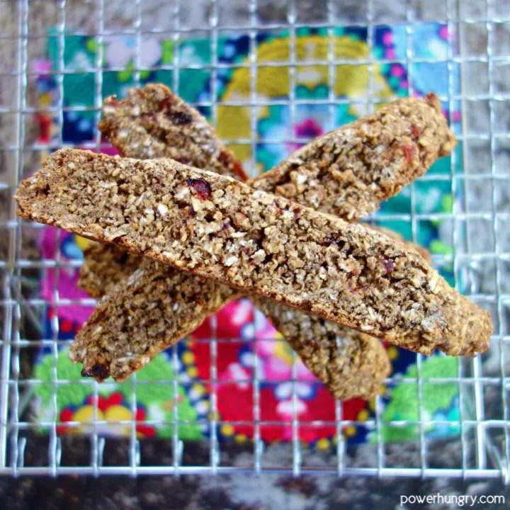 Flourless, vegan oat biscotti on a wire cooling rack with a colorful napkin