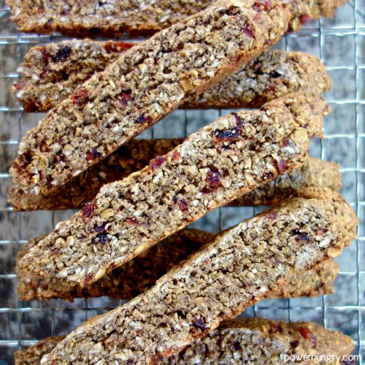 Vegan oat biscotti stacked on a wire cooling rack.