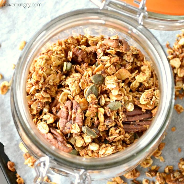 overhead shot of fresh apple pie granola in a covered glass container