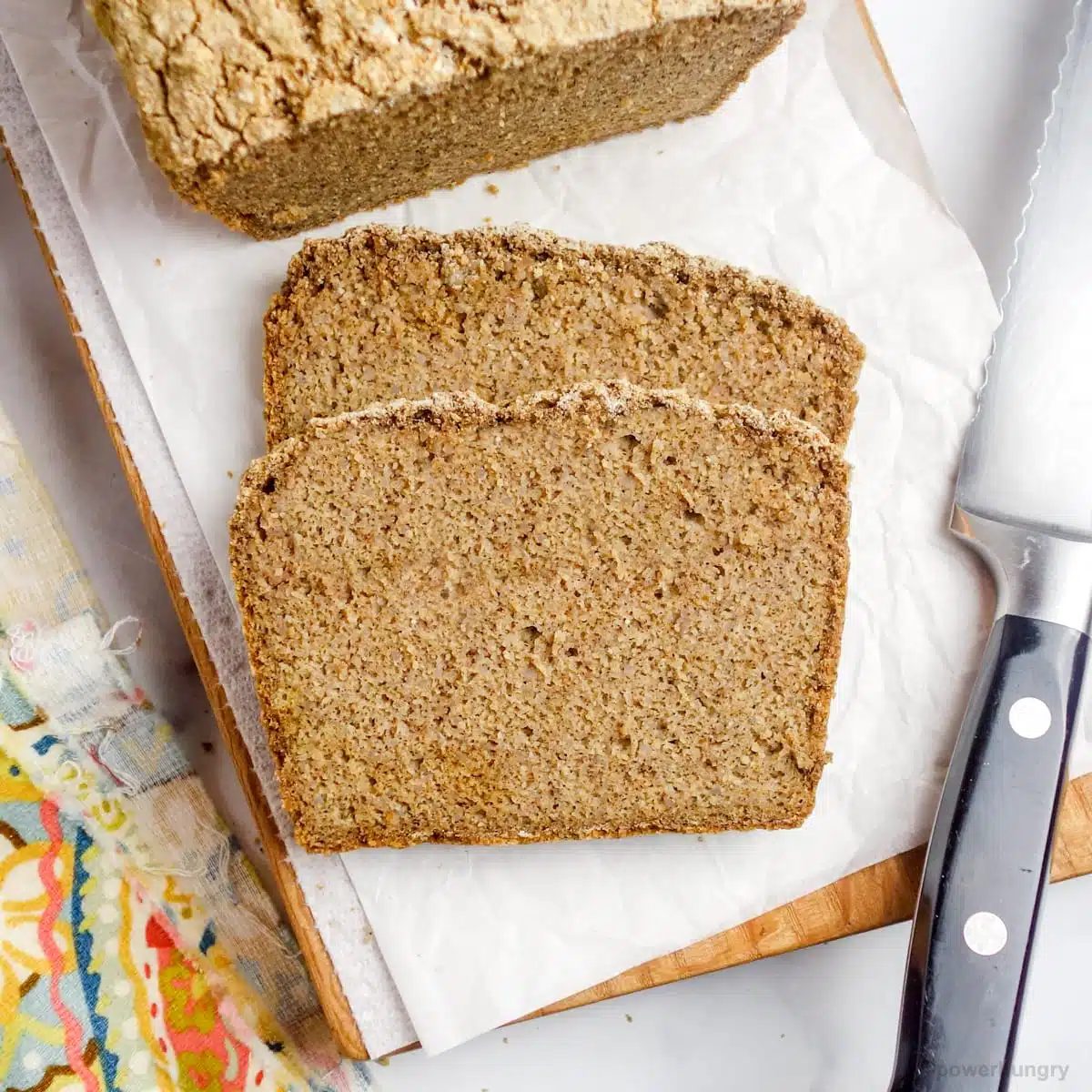 overhead shot of slices of gluten-free bread on a wood cutting board